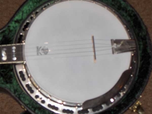 The Custom Greg Deering Limited Banjo with multi-colored Abalone pearl, which is inlaid alongside the Ivoroid binding