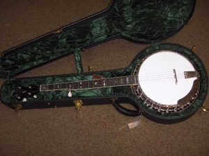 The Red Fox Banjo has nickel plated hardware and warm reddish-brown stain on the neck and resonator -1
